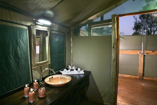 Moremi Crossing, safari tent open air bathroom, Botswana and Zimbabwe