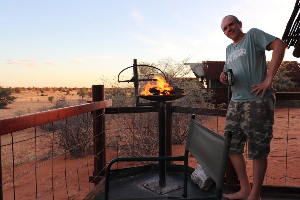 Enjoying a brass and beer with the stunning Kalahari Desert in the background at Gharagab Wilderness Camp in the Kgalagadi Transfrontier Park