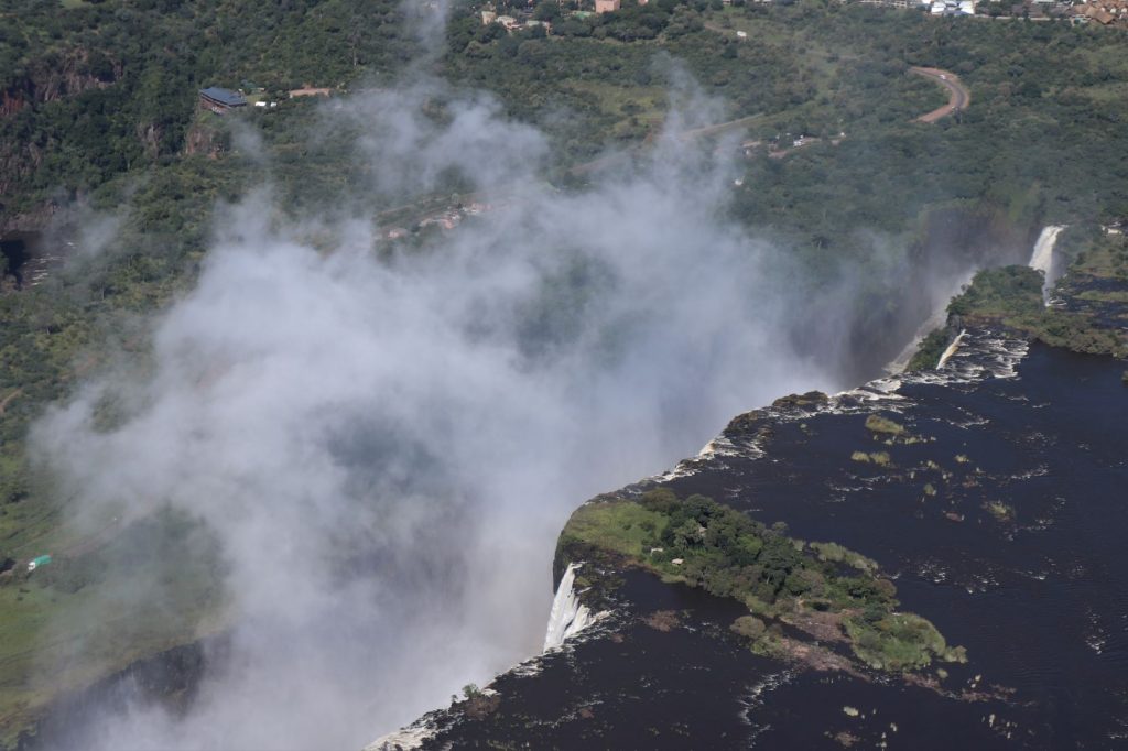 An aerial close up of the edge of the Victoria Falls and the fall's spray.