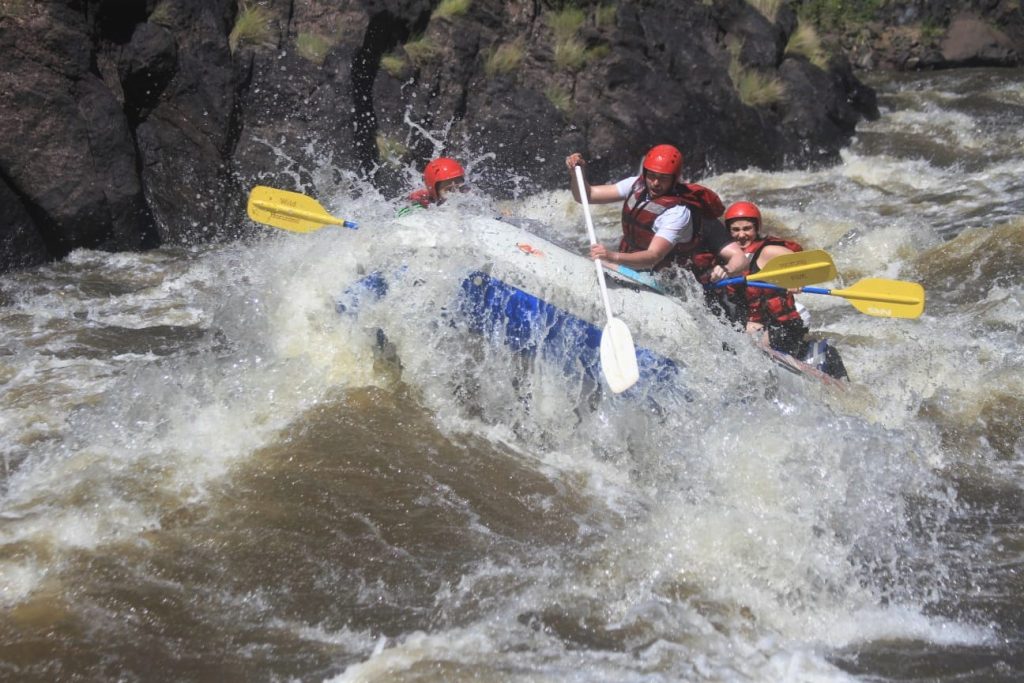 The raft crests a wave as it goes through this rapid.