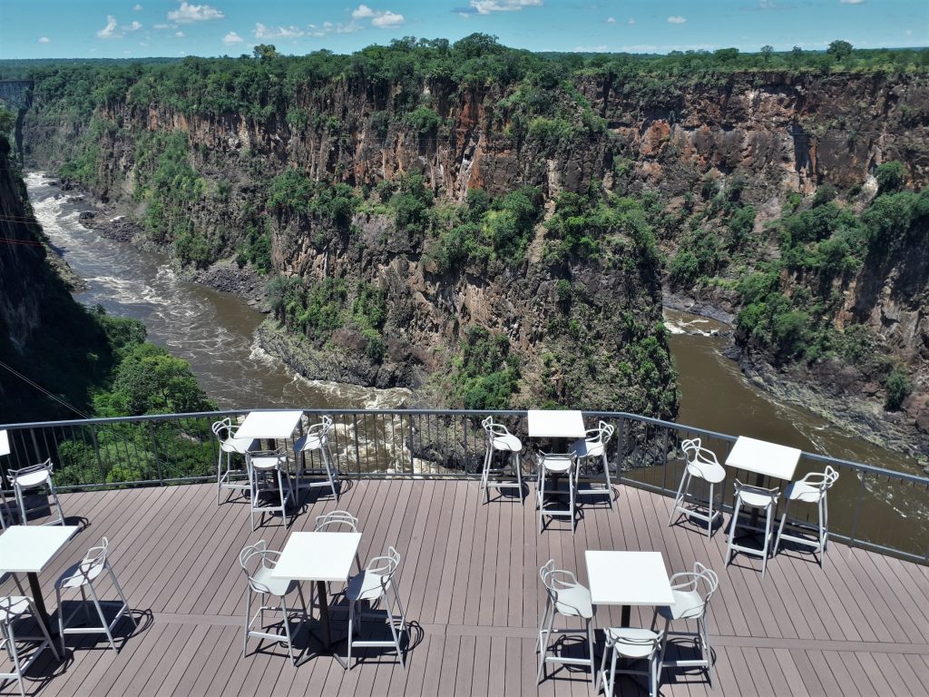 The outdoor tables of the Lookour Cafe with a magnificent view over the Batoka Gorges below the Victoria Falls