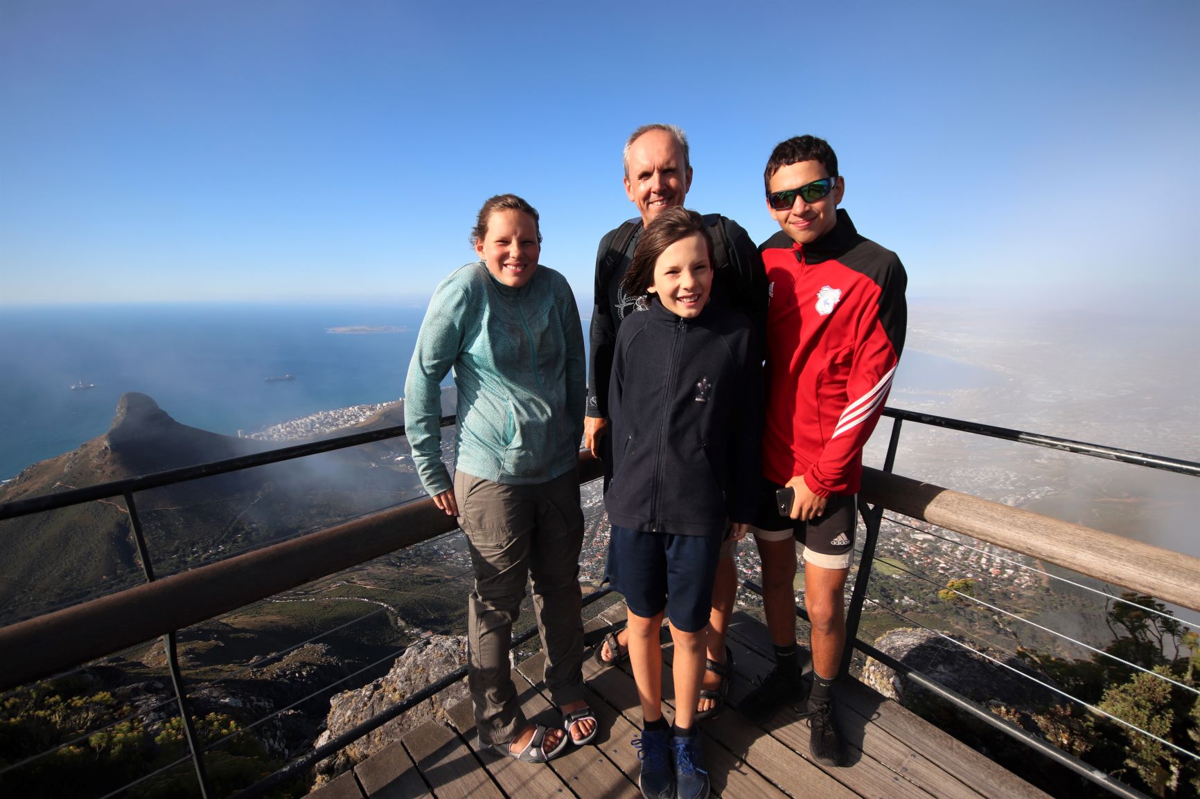 Chris and the kids on top of Table Mountain with a view of Signal Hill in the background