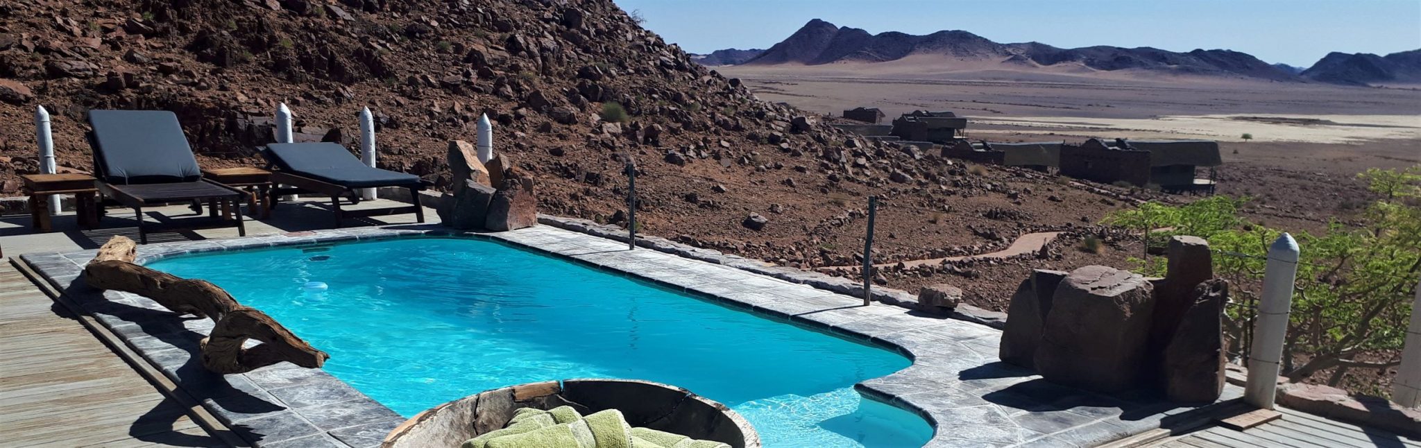 Southern Africa self-drive accommodation options - stunning pool with a view over the stark desert landscape near Sossusvlei, Namibia