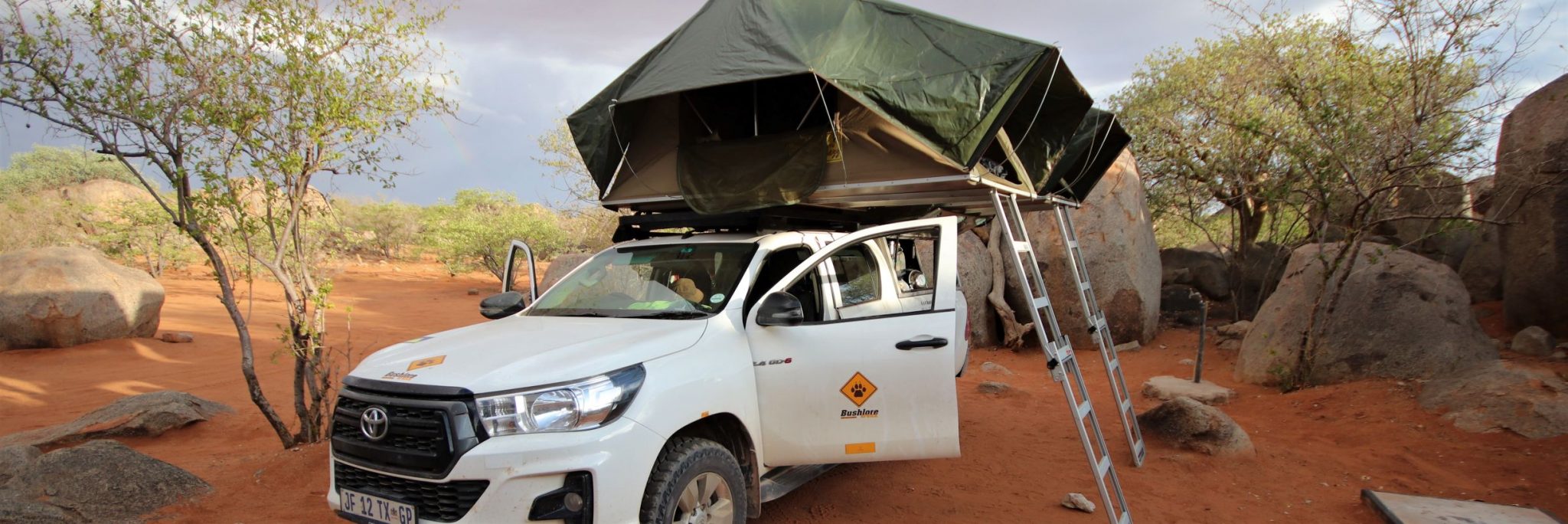 A hired Toyota Hilux 4WD with its roof top tent set up in a stunning campsite called Hoada in northern Namibia