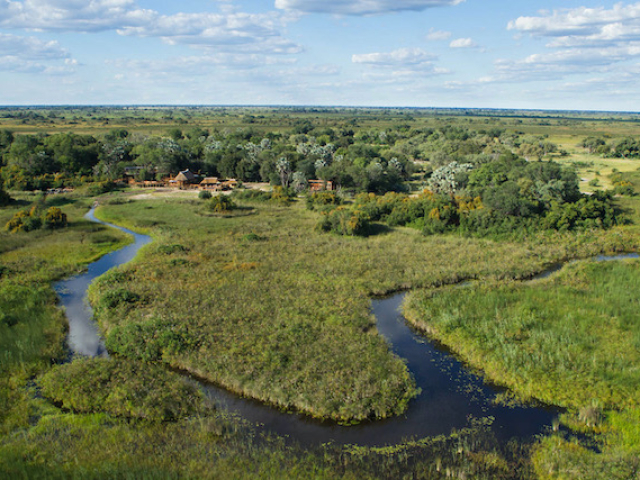 Camp Okavango, aerial view of lodge nestled amidst the delta waterways, Okavango Delta, Botswana